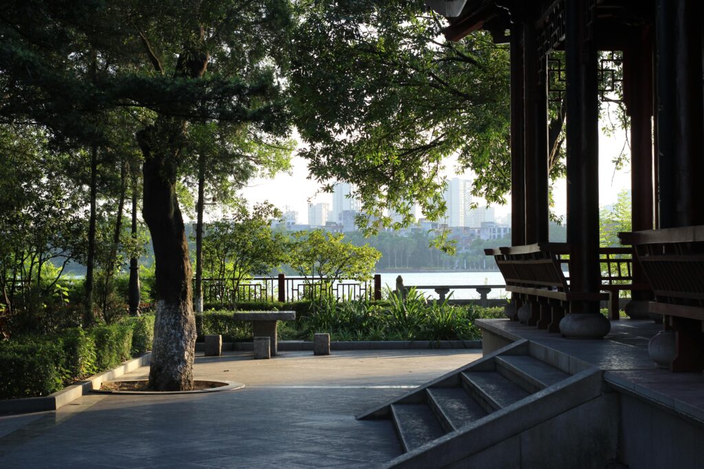 Peaceful park view with lush trees and a traditional pavilion at sunset from Do I Need a Retreat or Just a Break? from Drive to Retreats